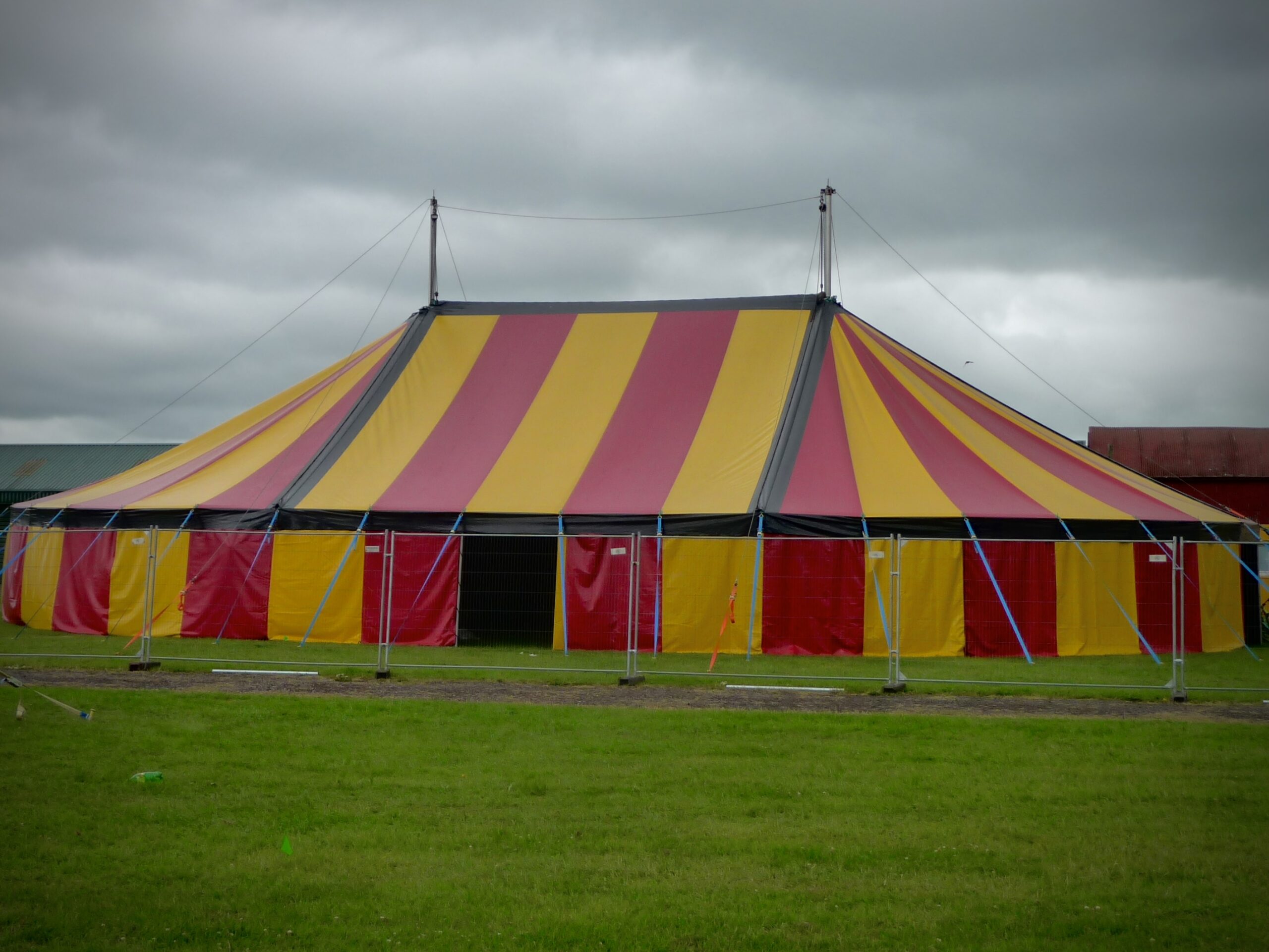 Red and yellow big top tent with two king poles